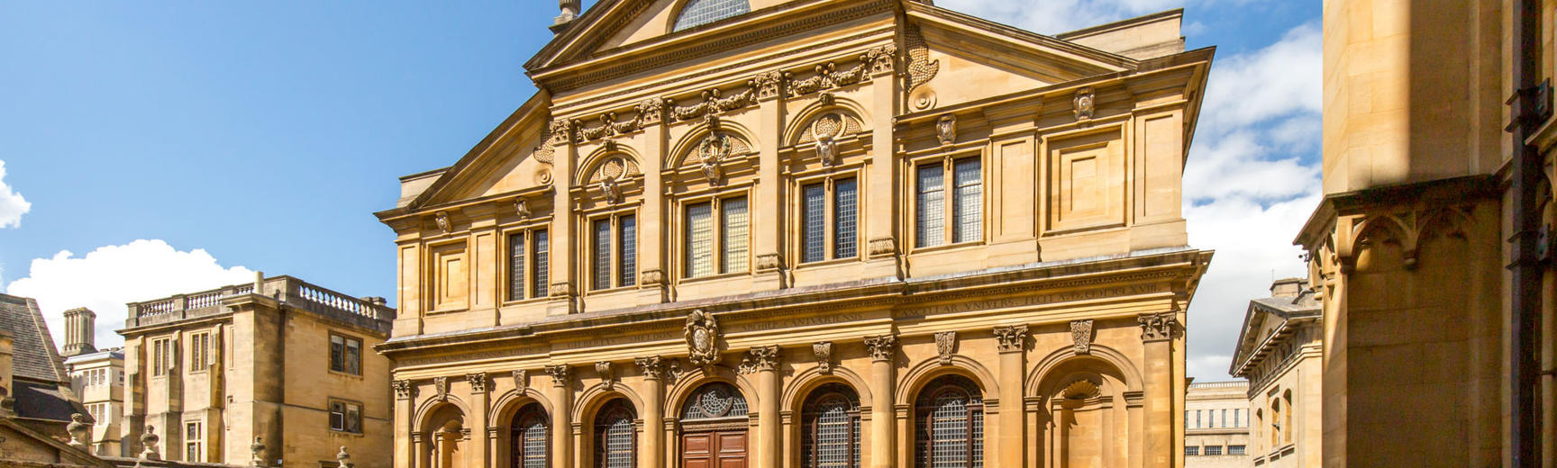 External photo of the Sheldonian Theatre with sunshine reflecting on the front