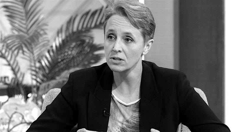 Kathleen Stock sits mid-discussion in a black blazer, her short hair combed to one side. 