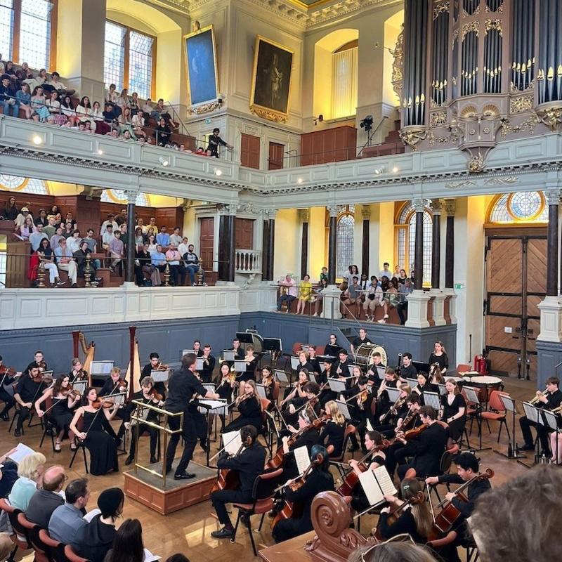 The Oxford University Orchestra playing in the Sheldonian Theatre's Auditorium.