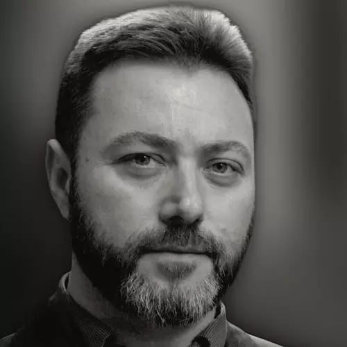 Man with beard staring at camera in black and white