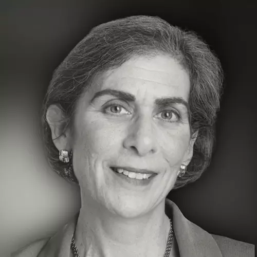 Woman with short hair slightly smiling while looking at the camera in black and white